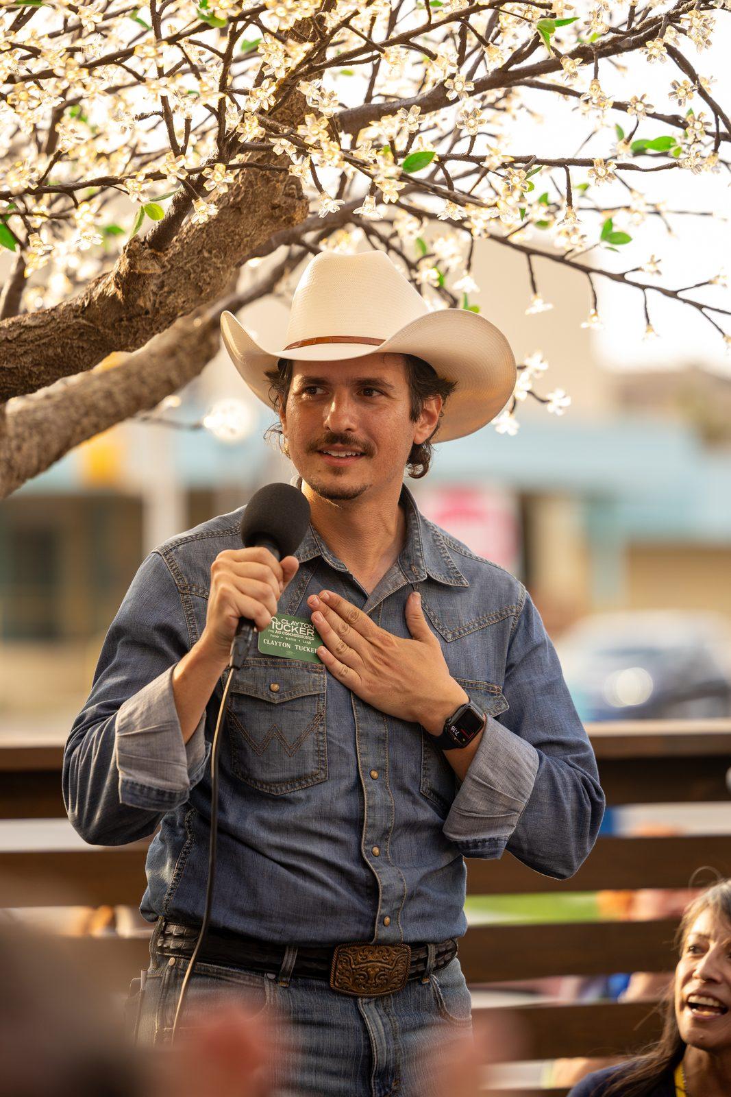 Clayton Tucker speaking into a microphone